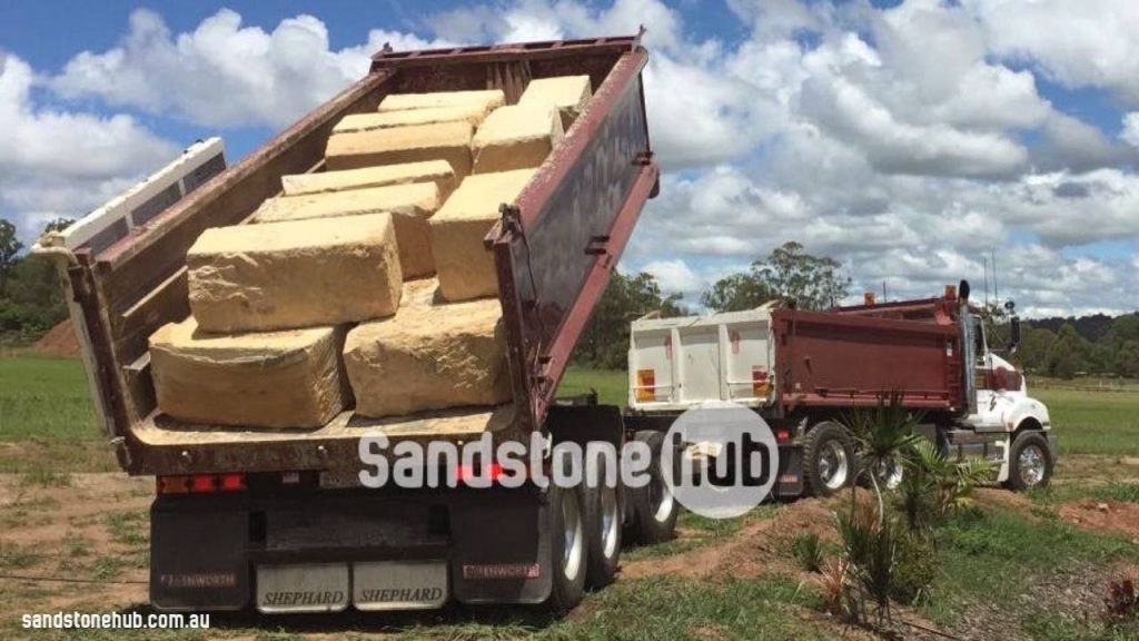 Sandstone Blocks Logs Being Unloaded From Tip Truck