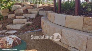 Sandstone Blocks Logs Retaining Wall And Outdoor Landscaping