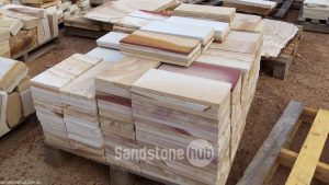 Sandstone Tiles and Pavers Assortment of Natural Colours Stacked on Pallet