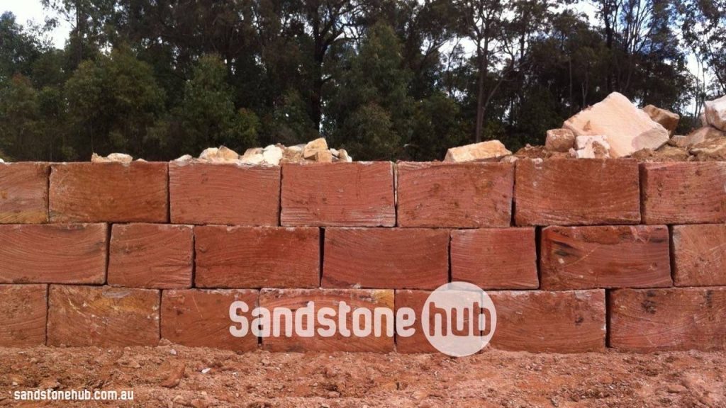 Sandstone Retaining Wall Under Construction With Wheel Sawn Red Blocks